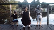 toddlers watching ducks in a pond 