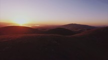 Aerial over hills during sunset | Inspirational | Valley | Sunrise | Drone | Sky | Light | Movement | Man | World | Landscape | Nature and Creation | Glory | Sun | Earth