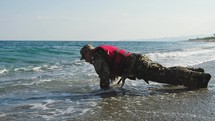 Miltary marine american man training push up chest exercise on the shore