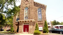 Front of a small local brick faced church 