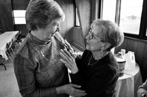 elderly women hugging in friendship 