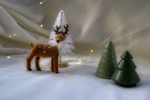 deer figurine and Christmas trees 