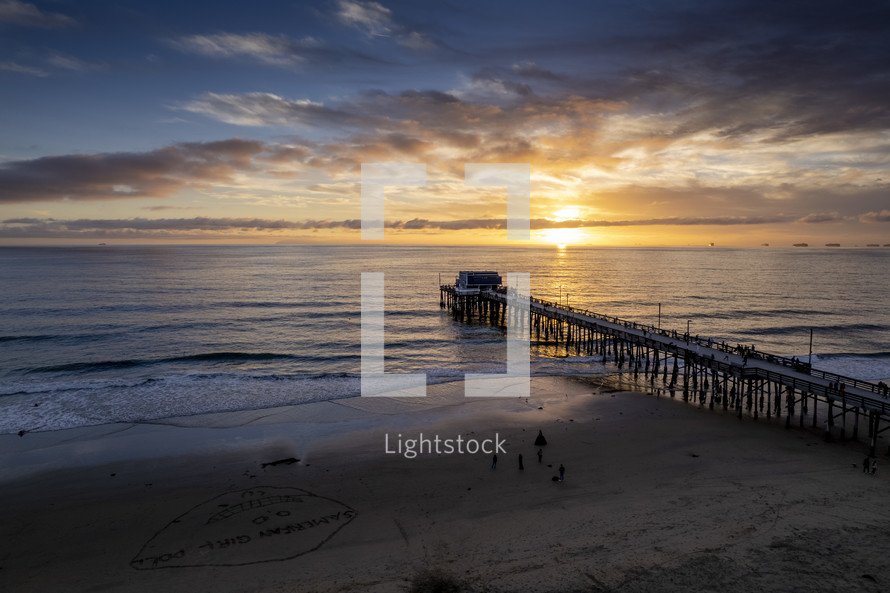 aerial view over a pier in Newport Beach, CA at sunset 