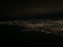 aerial view over a coastal city at night 