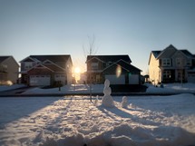 family of snowmen in a neighborhood 
