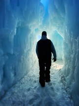 man exploring icebergs in a frozen landscape 
