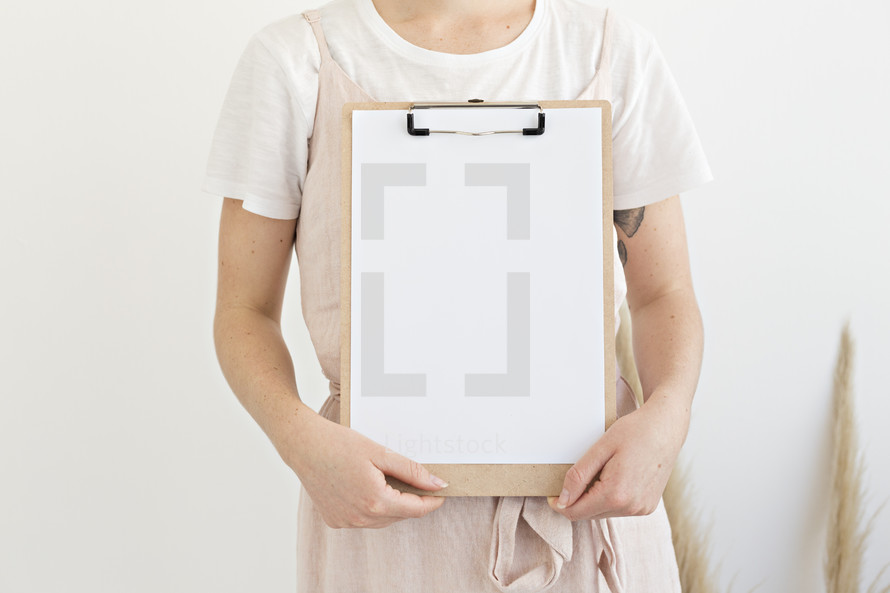 a woman holding a clipboard 