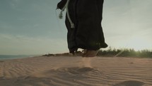 Feet Of A Monk Does Jump Rope On The Soft Sand Beach
