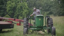 a man riding a tractor 