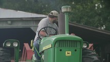 a farmer driving a bailing tractor 