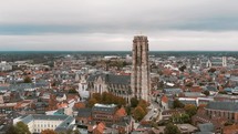 St. Rumbold's Cathedral (Sint Romboutskathedraal), Mechelen, Belgium. Aerial scenic cityscape. Orbiting shot