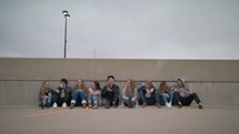 youth sitting and talking on the top of a parking garage 