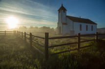 morning sunlight and a rural white church 