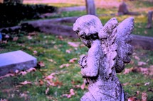 Visiting Cherub Angel praying and kneeling at the tomb of a dear loved one who has died and gone home.