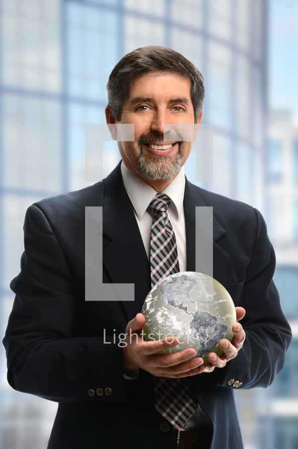 Businessman holding a globe 