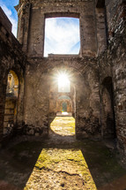 sunlights shining on the ruins of a cathedral 