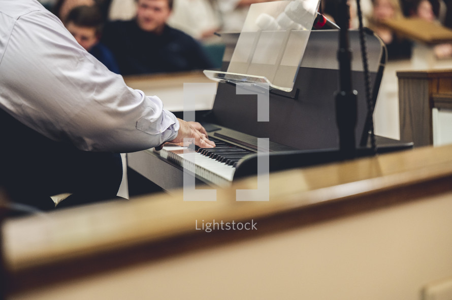 man playing a piano at church 
