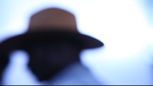 blurry image of a man in a hat 