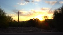 Driving point of view at sunrise with a colorful sky