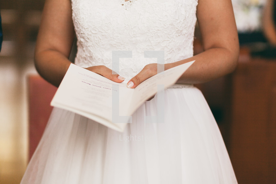 a bride holding a bulletin 