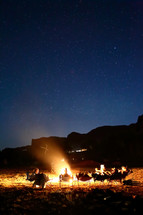 sitting around a campfire under starlight 