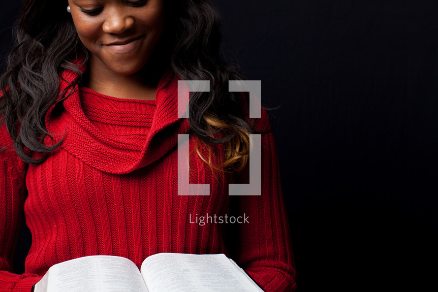 A woman reading a Bible. 