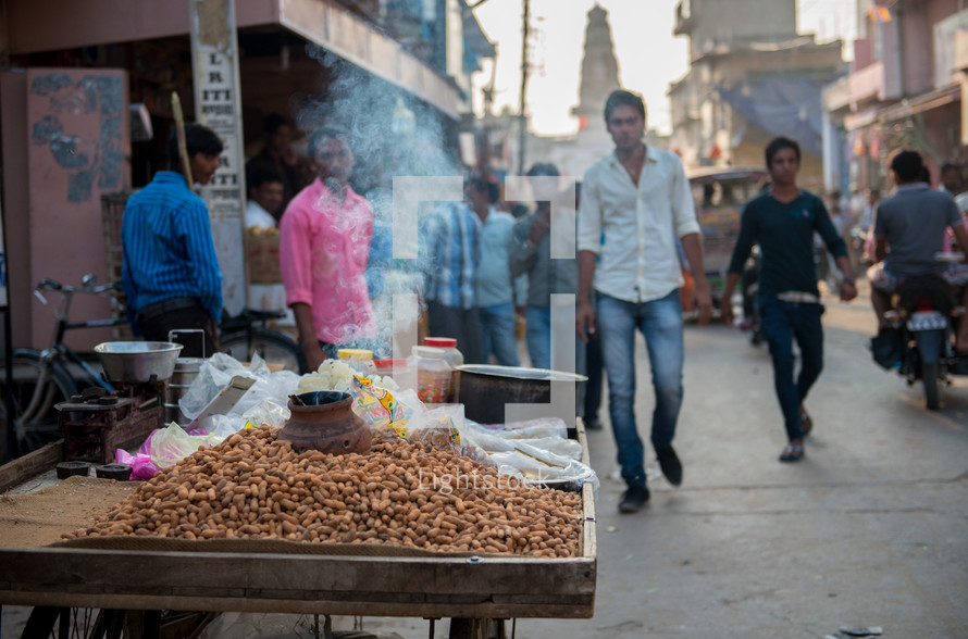 roasting peanuts on a street in India 