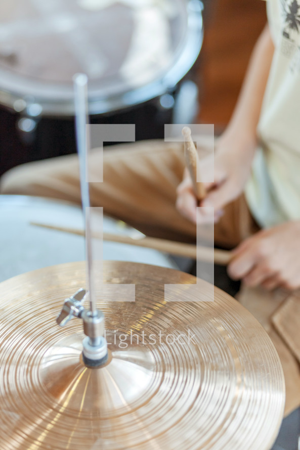 Boy drumming on a drumset