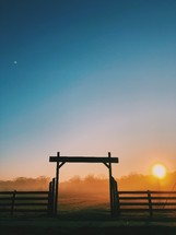 gate and fence on a ranch at sunrise 