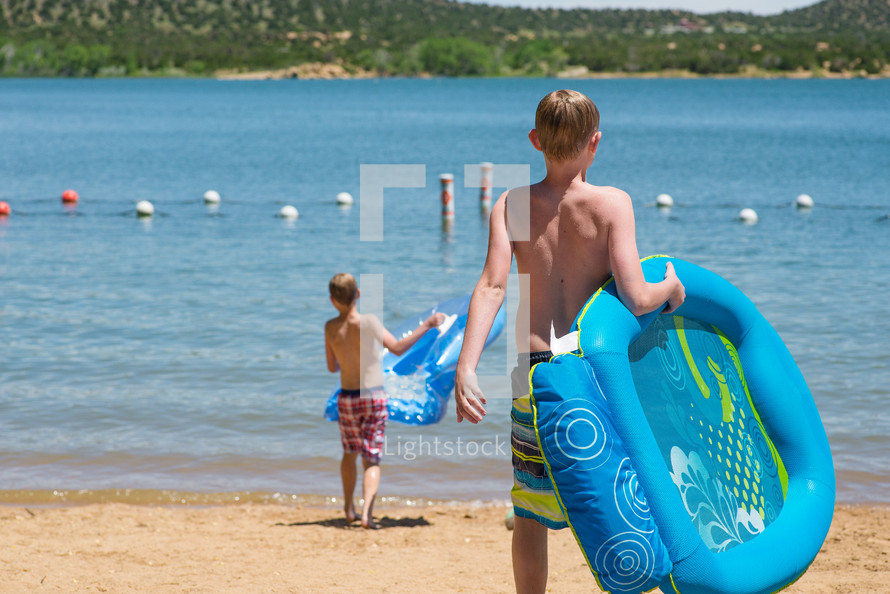 a boy with a float on a beach 