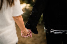 couple walking holding hands 