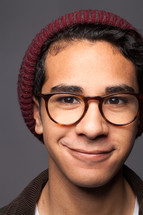 A smiling young man in glasses.