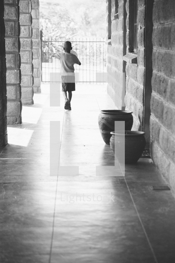 boy child walking down a hall 