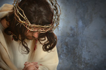 Jesus with a crown of thorns praying 