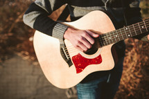 teen boy playing a guitar 