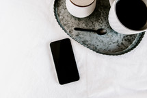 galvanized tray, coffee, sugar, spoon, and cellphone 