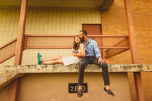 couple sitting and hugging on a ledge