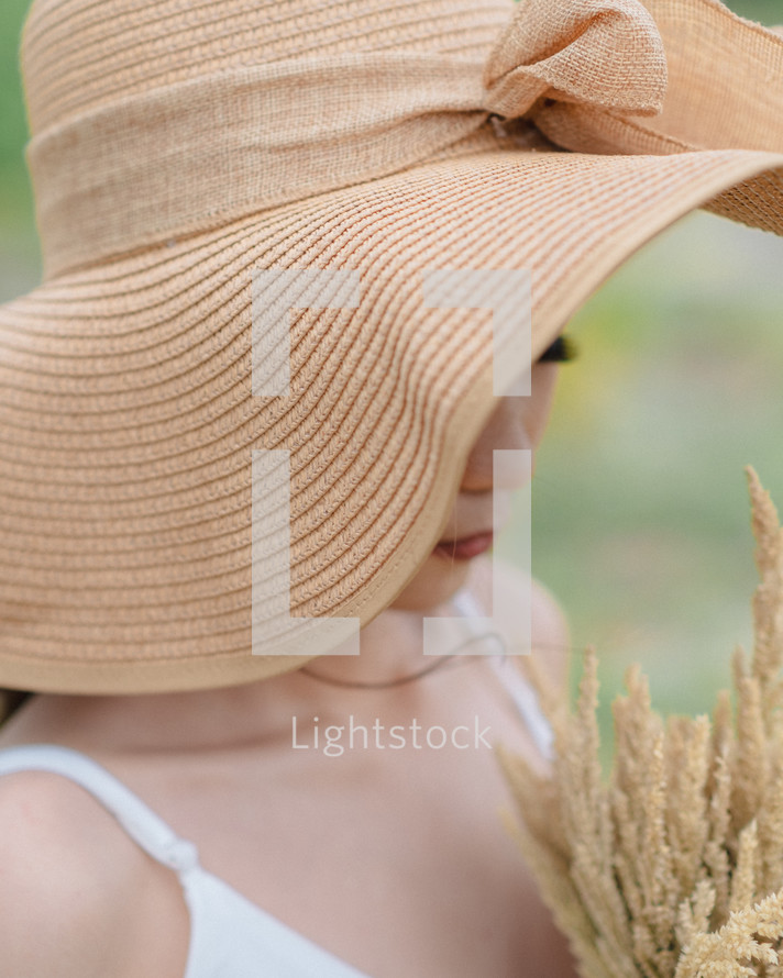a young woman in a sunhat 