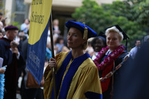 doctorate holding a banner at a graduation ceremony 