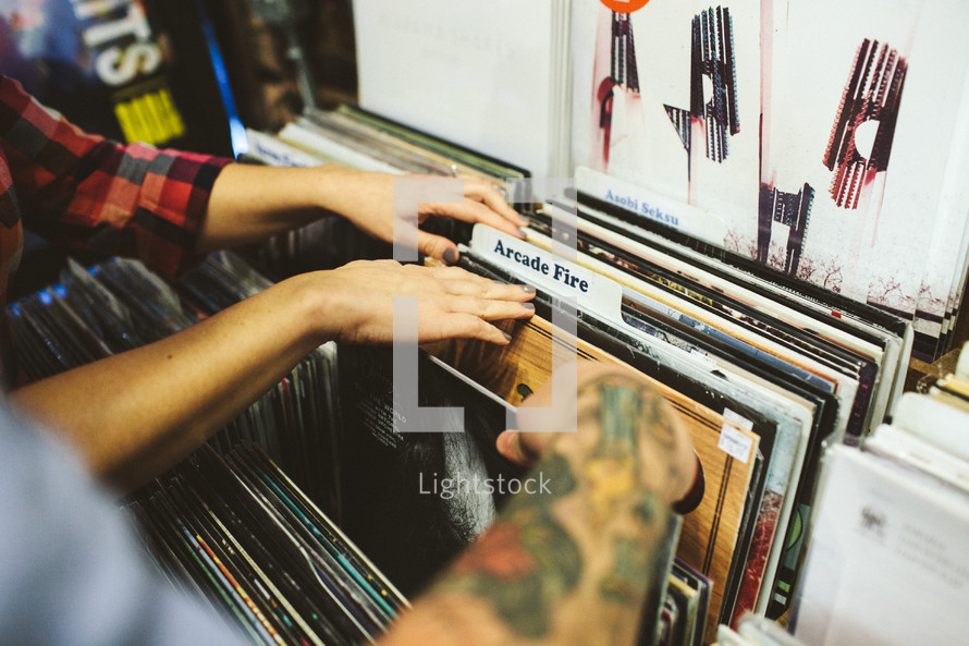 a couple looking through records at a record store 