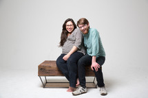 Couple sitting on a love-seat.