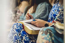Woman taking notes during a church service