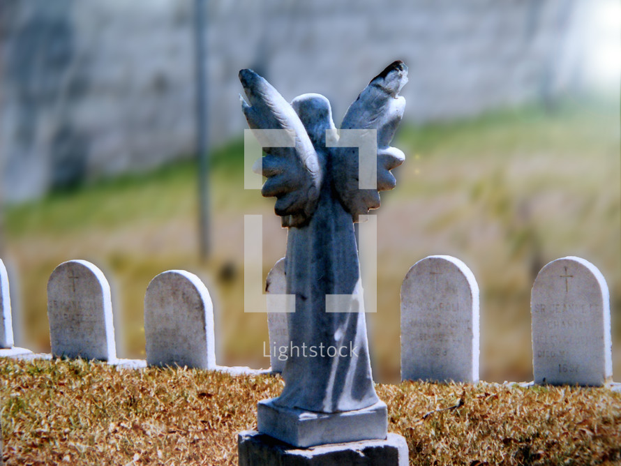 A Guardian angel statue stands guard over a group of children's graves in a cemetary. It is a humbling sight for a parent to have to bury their children but even in death there is victory as the scripture says in 1 Corinthians 15:55- - O death, where is thy sting? O grave, where is thy victory?

