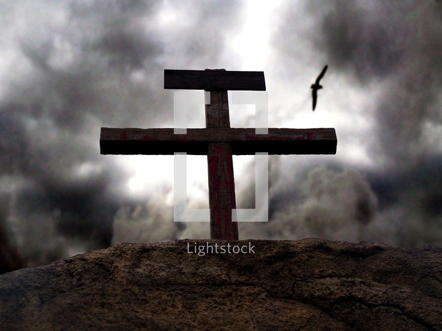 Dark skies gather around the rugged, bloodied cross on Gogatha where Jesus died on the cross for the sins of mankind. 