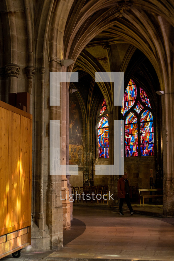 person walking through a cathedral 