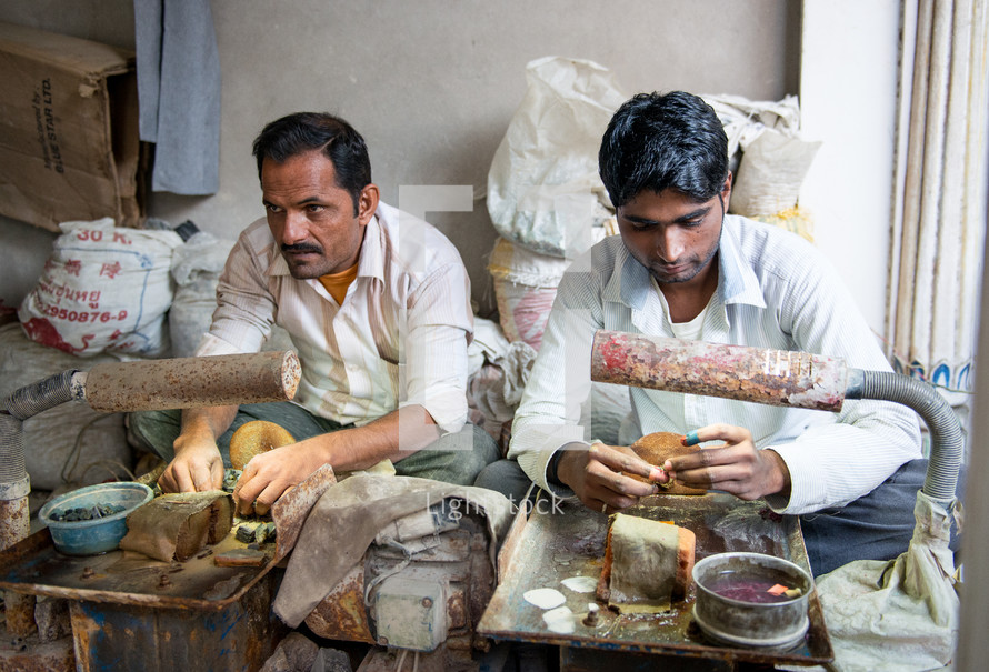 men making clothes in India 