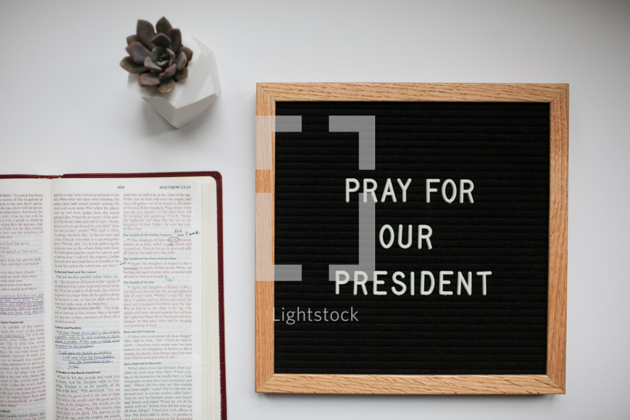 pray for our president sign and open Bible 