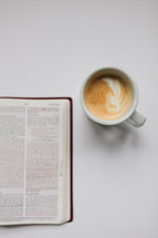 open Bible and latte on a white background 