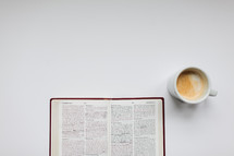 open Bible and mug on a white background 