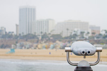 Binocular viewer on the beach overlooking Santa Monica.